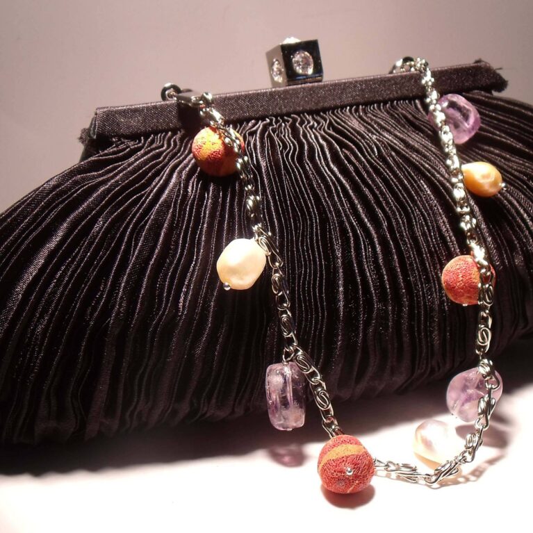Black satin clutch with pleated pattern, pearls, amethyst and madrepora