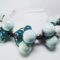 Necklace in cotton with "grapes" of white and green ceramic