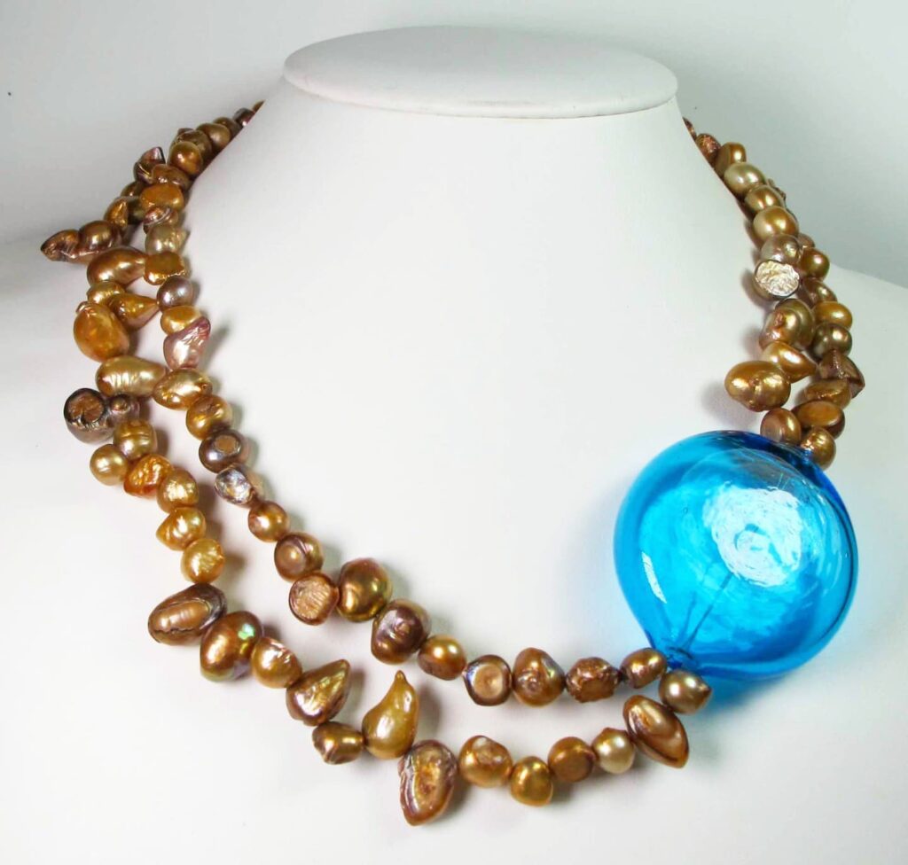 Two strands necklace with golden baroque pearls and Murano glass boule