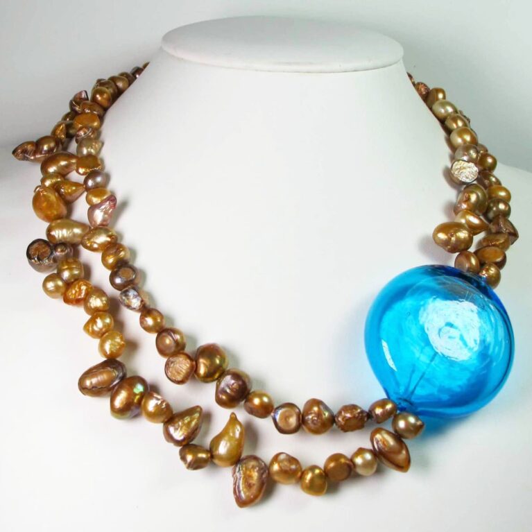 Two strands necklace with golden baroque pearls and Murano glass boule