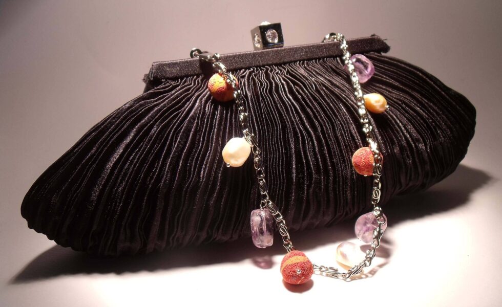 Black satin clutch with pleated pattern, pearls, amethyst and madrepora